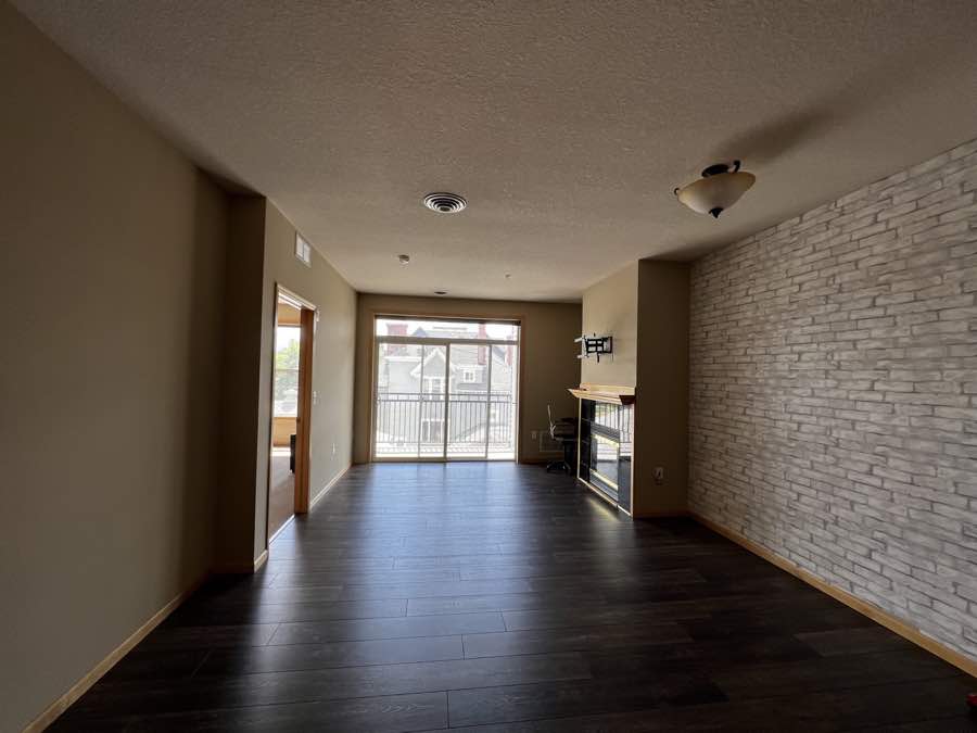 Empty living room with dark floors