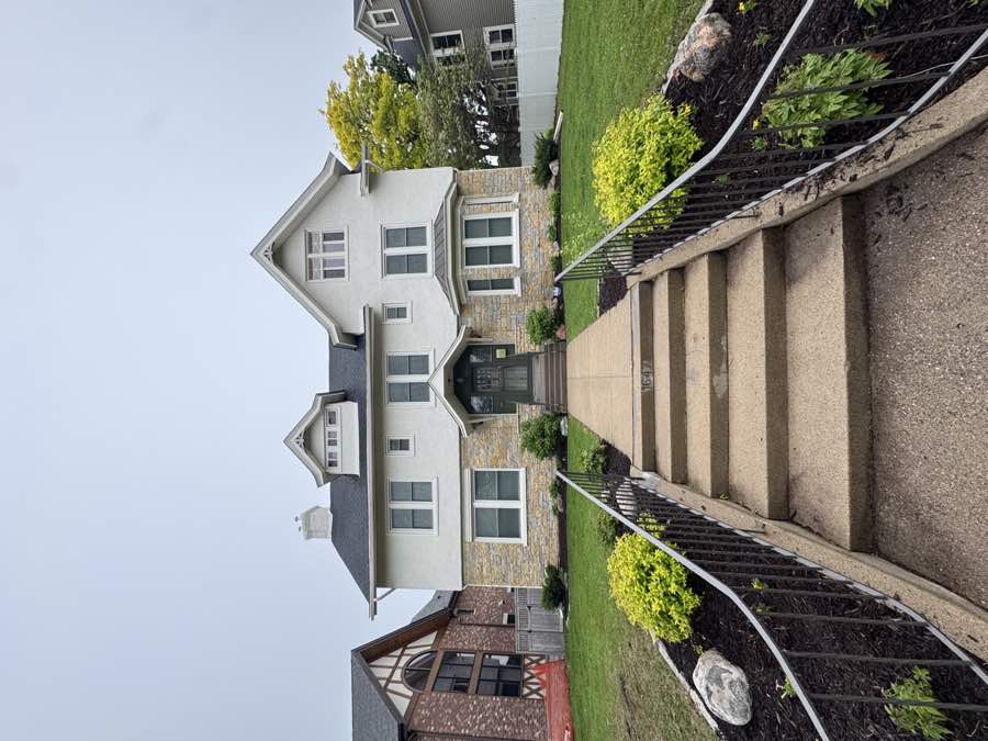 White house with landscaped front yard